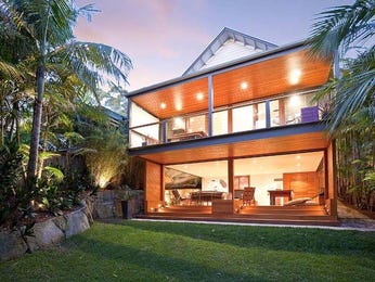 Multi-level outdoor living design with balcony & rockery using brick ...